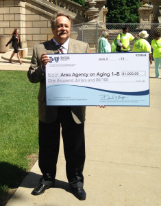 George Wojdacki shows off the check he received as the winner of the Claude D. Pepper Award