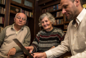 Senior couple going over paperwork with advisor