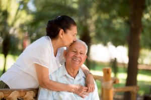 wife embracing elderly husband