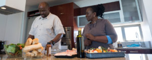 couple cooking a healthy meal together in a large kitchen.