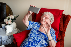 Elderly woman video chatting with family during coronavirus pandemic