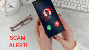 Scam Alert graphic. Women's hands holding cell phone with incoming call coming in and "Scam" superimposed on screen.