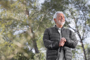 An older man on a walk outdoors.