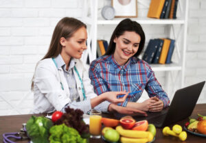 Two young girls studying at the kitchen table.