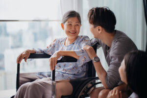 An older women in a wheel chair, enjoying time with her family.