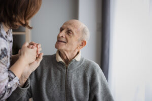 Elderly man looking at his daughter with love